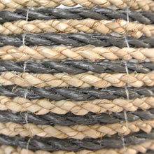Close up view of the hand woven mixed small black basket with natural and black stripes